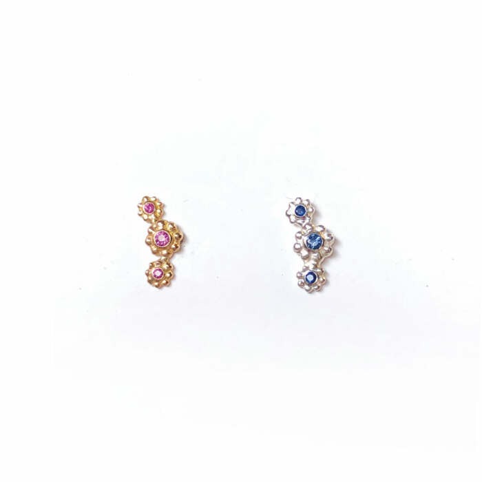 La puce Lena Trio en argent 925 sertie de saphirs bleus et la puce Lena Trio en or rose 18 carats Fairmined sertie de saphirs roses